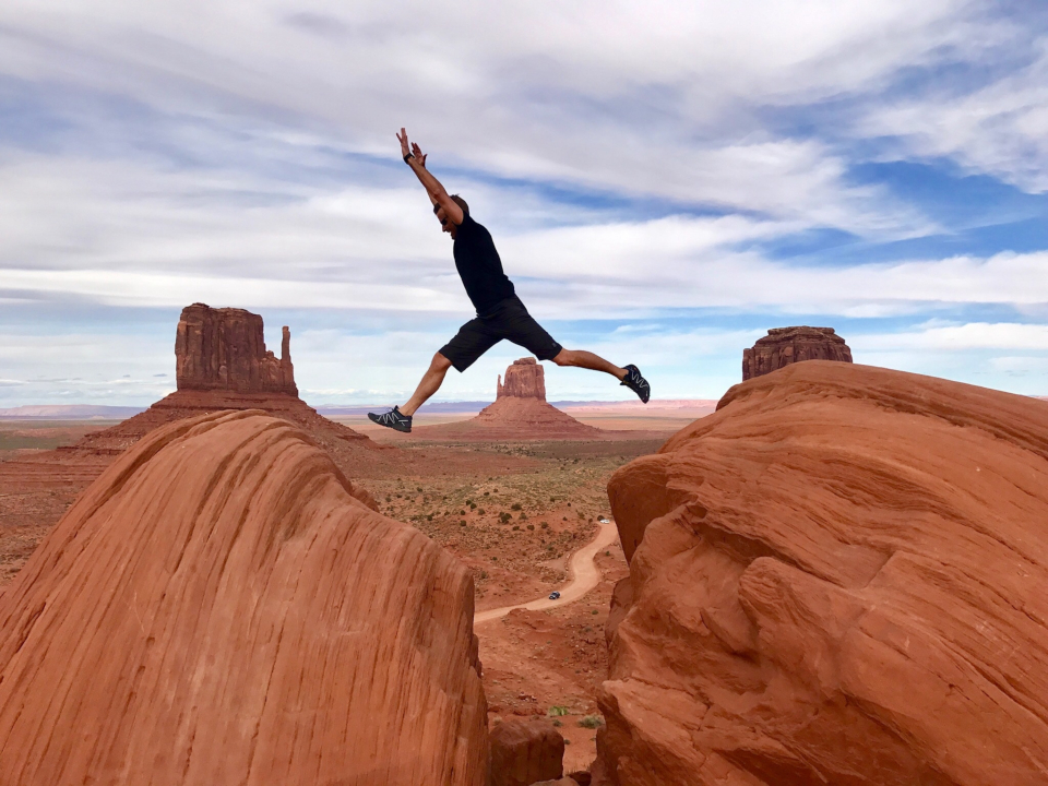 Man jumping across a canyon.